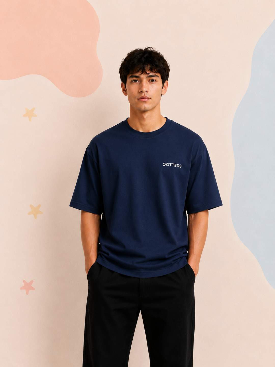 Man wearing a navy blue t-shirt with 'DOTTED' logo against a pastel abstract background